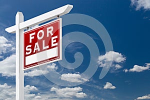 Right Facing For Sale Real Estate Sign Over Blue Sky and Clouds