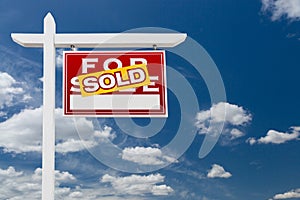 Right Facing Sold For Sale Real Estate Sign Over Blue Skies