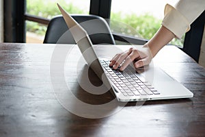 Right hand of asian woman put on laptop