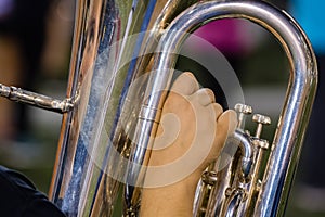 Right hand of a baritone player at rehearsal