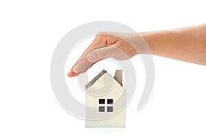 Right hand covering a small family house with clipping path