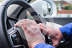 Right hand drive car, hand on the wheel honk, driver& x27;s hands in the shot, cruise control buttons in the view photo