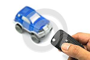 Right hand holding remote control car key for business concept