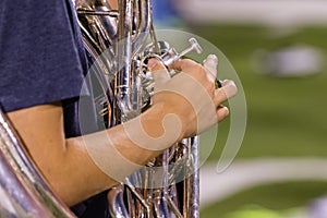 Right hand of a tuba player at rehearsal