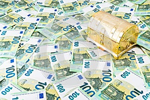 Right hand view on closed golden treasure chest on euro money bills, Pandora box concept of financial hazards