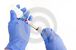 Right Handed Anesthesiologist Withdrawing Propofol into a Syringe photo