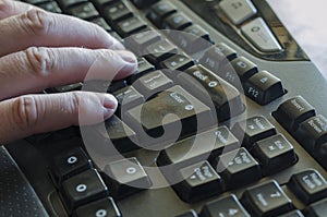 Right male hand on a black computer keyboard