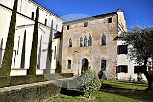 Right side of the church of Casalserugo and facade of the beautiful Venetian-style villa leaning against the wall of the church. photo