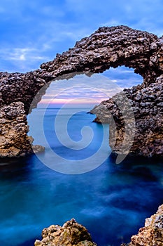 The Arch of Portitxol at the Mediterranean Sea Escala, Catalonia, Spain. photo