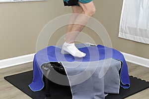 Right Side View of Lower Legs of a Male Rebounding on a Rebounder