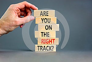 Right track symbol. Concept words Are you on the right track on wooden blocks on a beautiful grey table grey background.