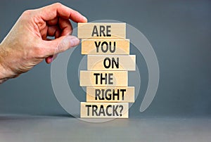 Right track symbol. Concept words Are you on the right track on wooden blocks on a beautiful grey table grey background.