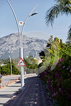 Right turn sign in front of mountain view and beautiful greenery. Modern road, turkish view