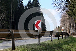 Right Turn Sign: Road signs warn of a sharp turn on a narrow road