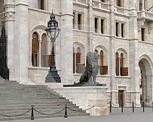 Right of two Bronze lion statues flanking the East entrance of the Hungarian Parliament Building, Budapest photo