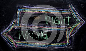 Right or Wrong written with color chalk concept on the blackboard