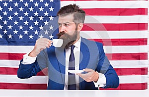 A rightful country. bearded man drink coffee cup. American education reform in july 4. American citizen at USA flag photo