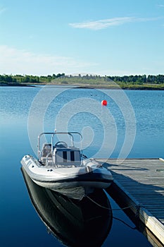 Rigid inflatable boat at a pier photo