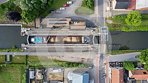 Rijkevorsel, Belgium, 25th of May, 2022, Aerial drone view of cargo boat in canal lock, landscape of a sluice from above