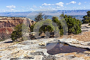 Rim of the Colorado National Monument with the Grand Valley in the distance