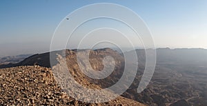 Rim of desert canyon at sunset