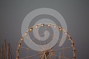 Rimini beach panoramic wheel at dusk; golden sunset light, vintage feeling. Italian Adriac coast summer