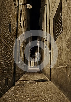Rimini, Emilia Romagna, Italy: dark narrow alley at night in the old town