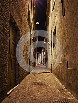 Rimini, Emilia Romagna, Italy: narrow alley at night in the old town 