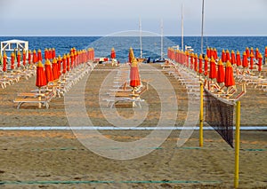 Rimini - Orange beach umbrellas and sunbeds