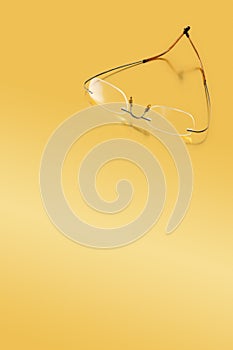 Rimless glasses on a golden surface