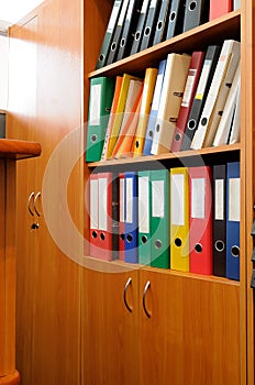 Ring binders in the storage cabinet.