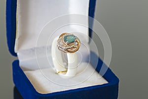 Ring with a blue stone in box