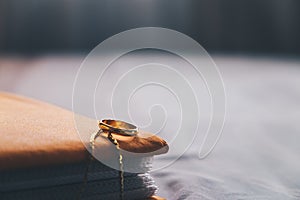 Ring and a book on the bed