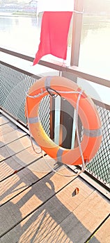 a ring buoy (tool for safety) attached to the fence.