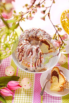 Ring cake with icing and chocolate glaze on easter table