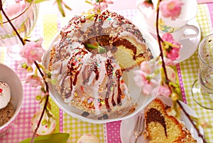 Ring cake with icing and chocolate glaze on easter table