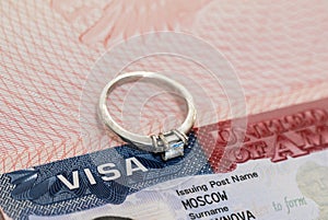 Ring with a diamond on the background of a US visa as a symbol of engagement