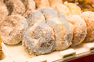Ring doughnut fresh from the bakery with sprinkle sweets and icing on top