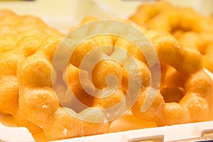 Ring doughnut fresh from the bakery with sprinkle sweets and icing on top