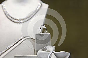 Ring with a huge diamond on the background of a sparkling Diamond necklace, studded with large diamonds