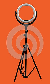 ring lamp on a tripod on bright red background