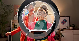 Ring light, dance and women in a house with social media, recording or fun content creation together. Podcast, creative