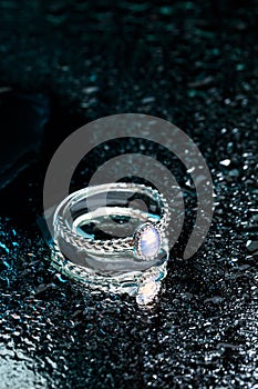 Ring with Moonstone   on black background  with water drops- Image