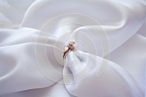 Ring with a pearl and brilliants and sateen