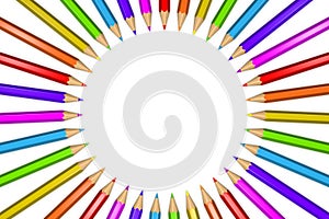 Ring of rainbow colored pencils creating a circle shape isolated over white background.