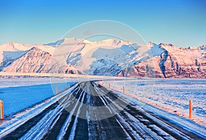 The Ring Road Route 1 on a sunny winter day to the snow-capped mountains, South of Iceland