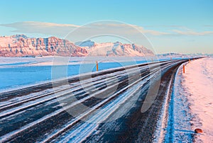 The Ring Road Route 1 on a sunny winter day along the snow-capped mountains between Hof and Jokulsarlon. South of Iceland