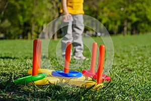 Ring throw summer game on a green lawn in the sun