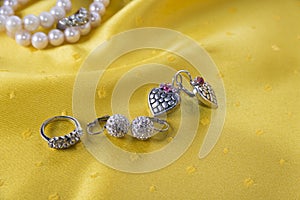 Ring and two pairs of earings on the yellow