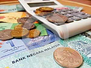 Ringgit Malaysia bank notes and coins with calculator.